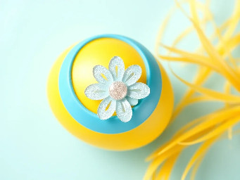 Yellow pastel egg, blue ring over yellow, sparkly flower and circle stickers