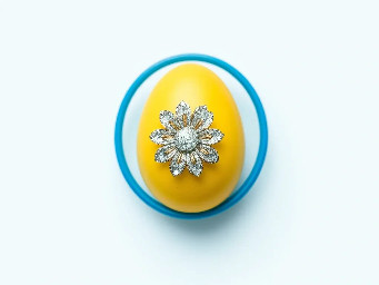 Yellow pastel egg, blue ring over yellow, sparkly flower and circle stickers